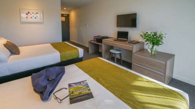 View from bed to flatscreen TV and entry way.