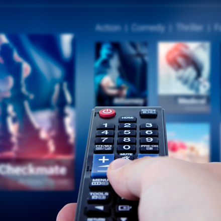 Close up of TV remote being held by hand