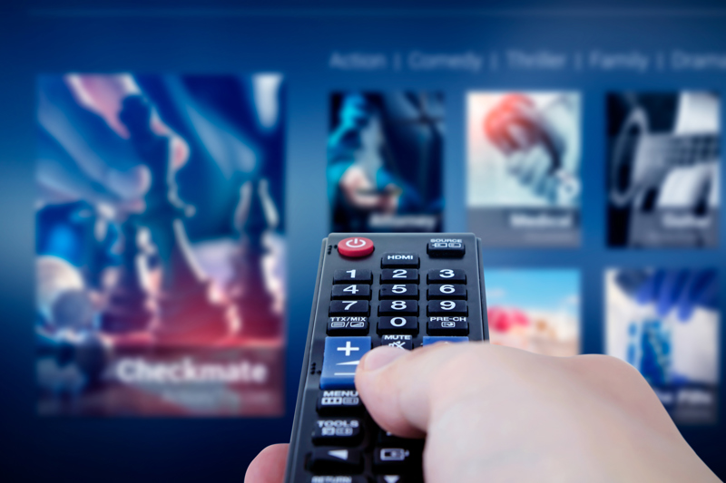 Close up of TV remote being held by hand