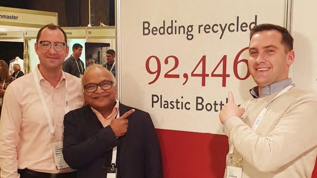 CEO - Sudesh with Vendella team and signage showing recycled plastic statistic for Sudima Hotels