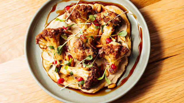 Baked cauliflower in hummus and pomegranate