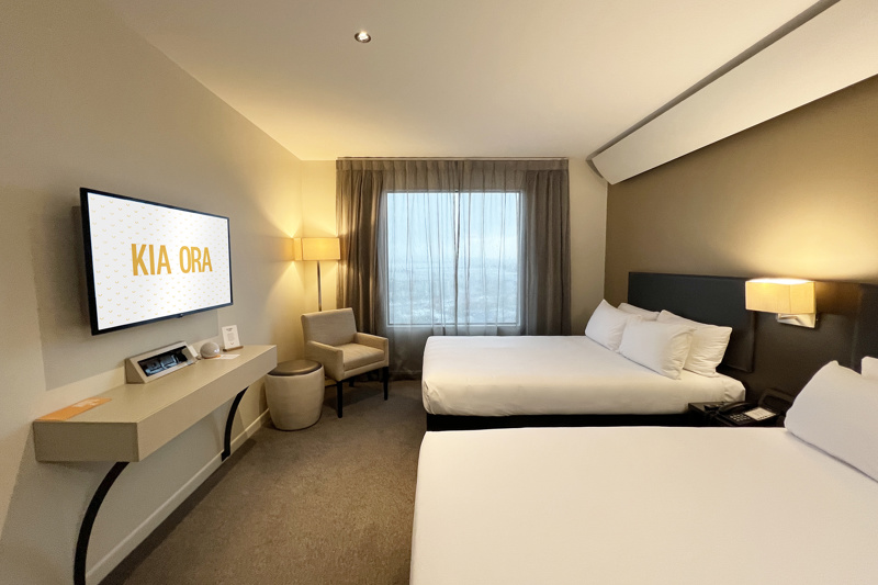 Superior twin room. Two large beds with lounge seat, desk and chair, flatscreen TV, ottoman and lamps